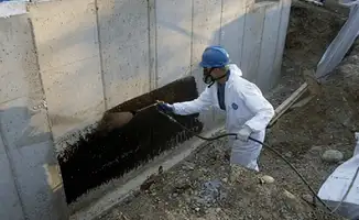 Professional waterproofing the exterior walls of the basement in Pasadena, CA